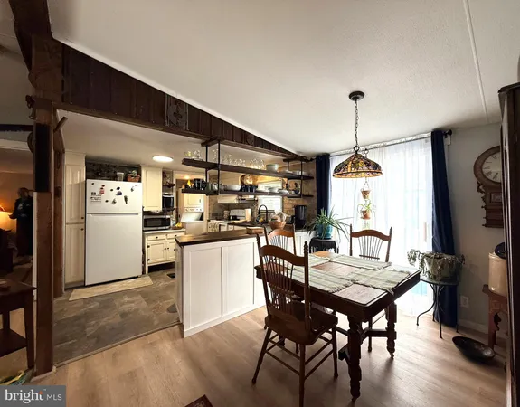 a kitchen with a table chairs refrigerator and cabinets