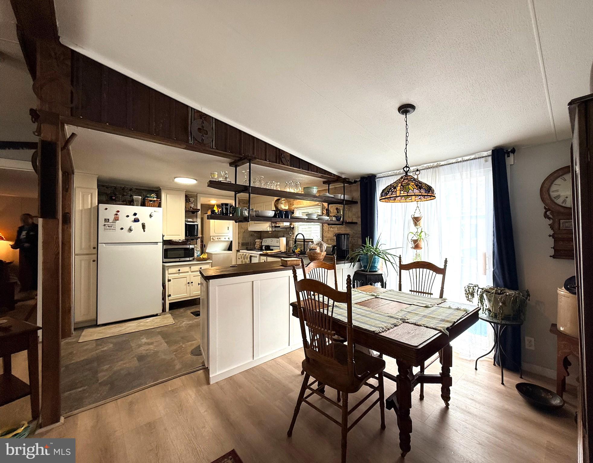 260 Marshall Mill Road, Unit 146 Malaga, NJ 08328 - Photo 8 of 34 a kitchen with a table chairs refrigerator and cabinets