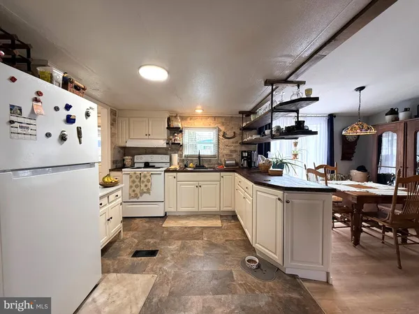a kitchen with cabinets and white stainless steel appliances