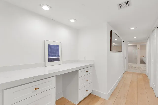 a spacious bedroom with a large bed and a window