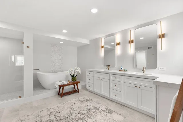 a spacious bathroom with a double vanity sink and a mirror