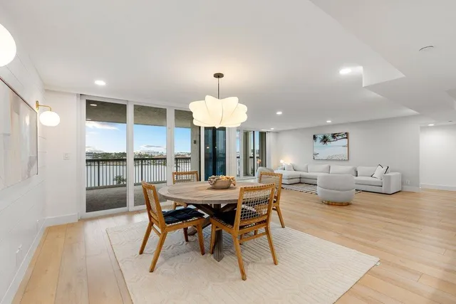 a dining room with furniture a rug and wooden floor
