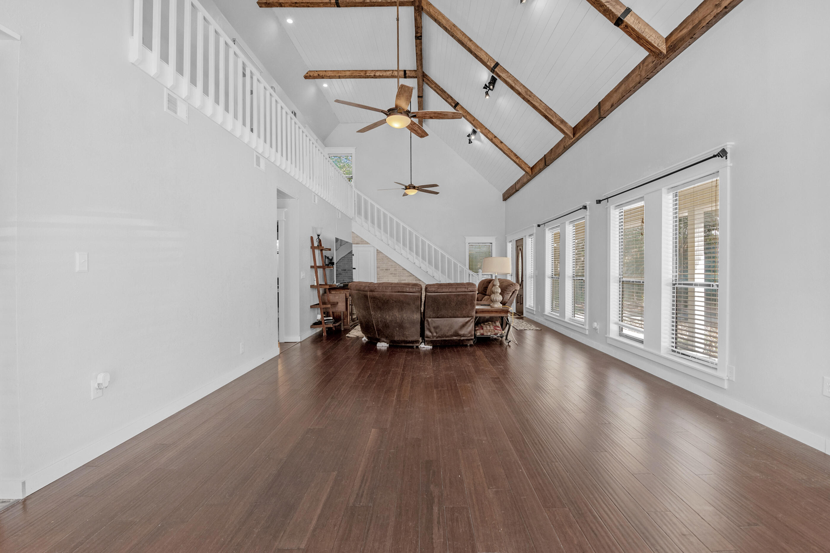 6539 Robar Tesora Street Navarre, FL 32566 - Photo 12 of 48 a living room with furniture wooden floor and white walls