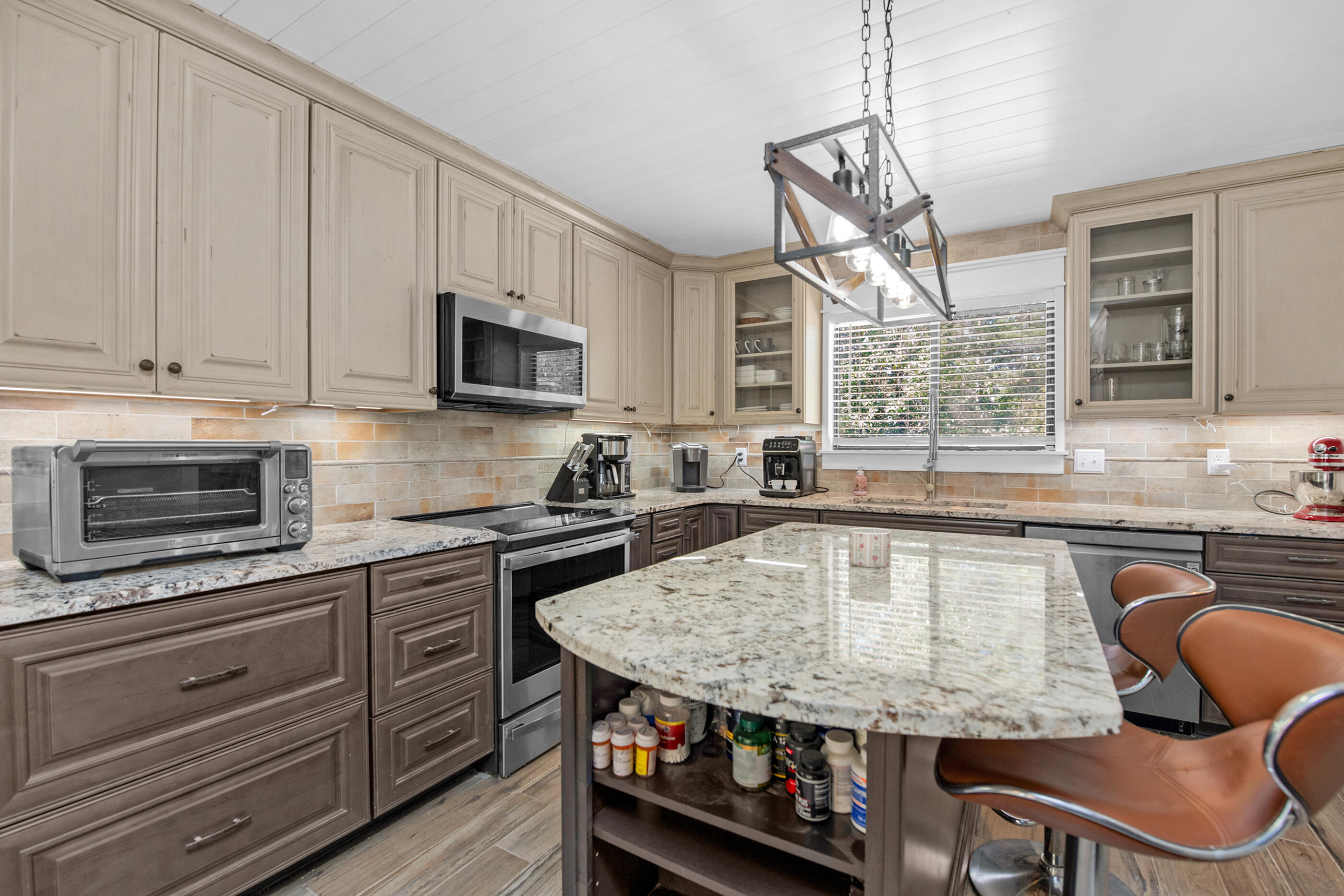 6539 Robar Tesora Street Navarre, FL 32566 - Photo 15 of 48 a kitchen with stainless steel appliances granite countertop a stove sink and microwave
