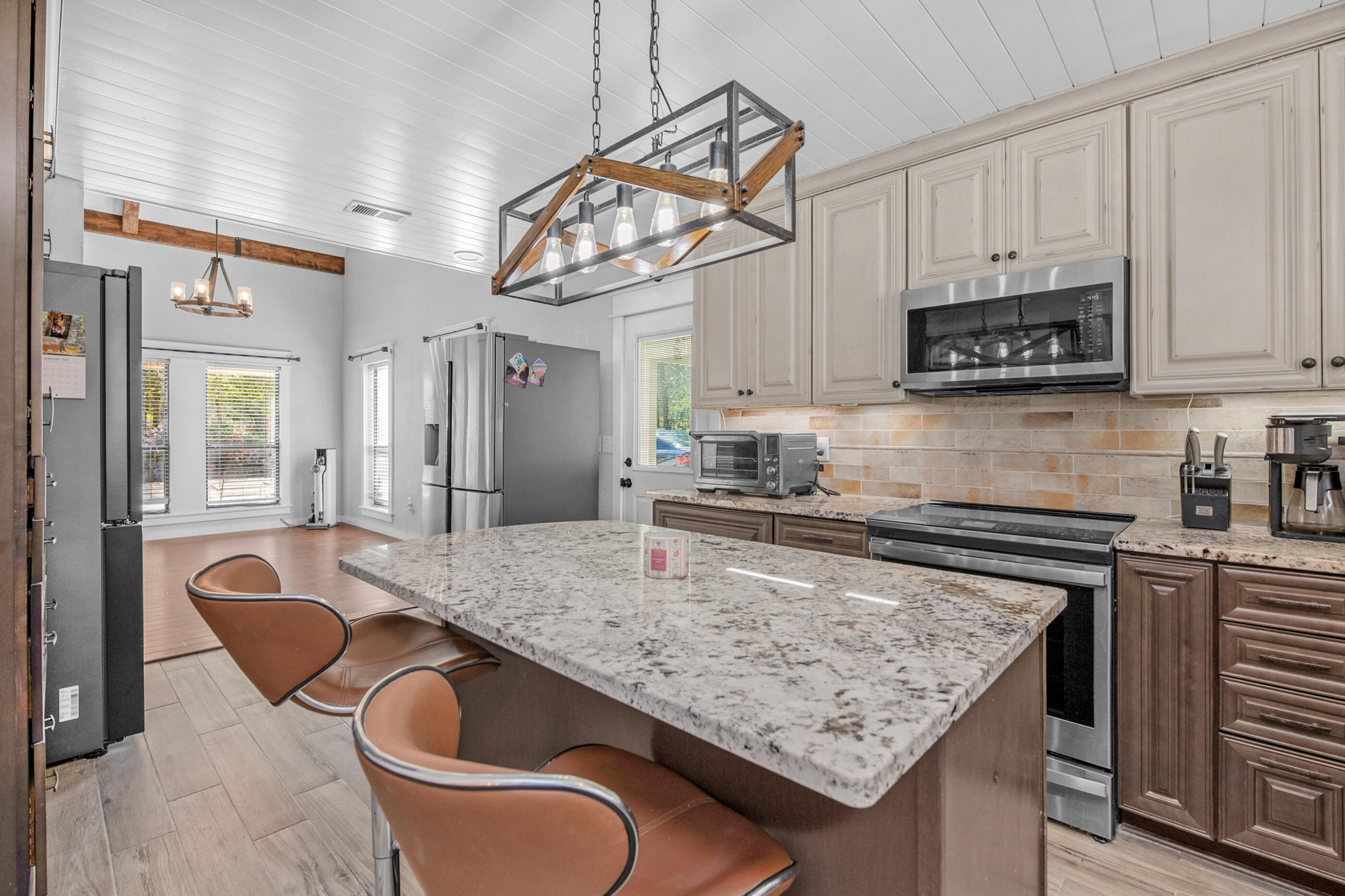 6539 Robar Tesora Street Navarre, FL 32566 - Photo 17 of 48 a kitchen with stainless steel appliances granite countertop a sink a stove and a wooden cabinets