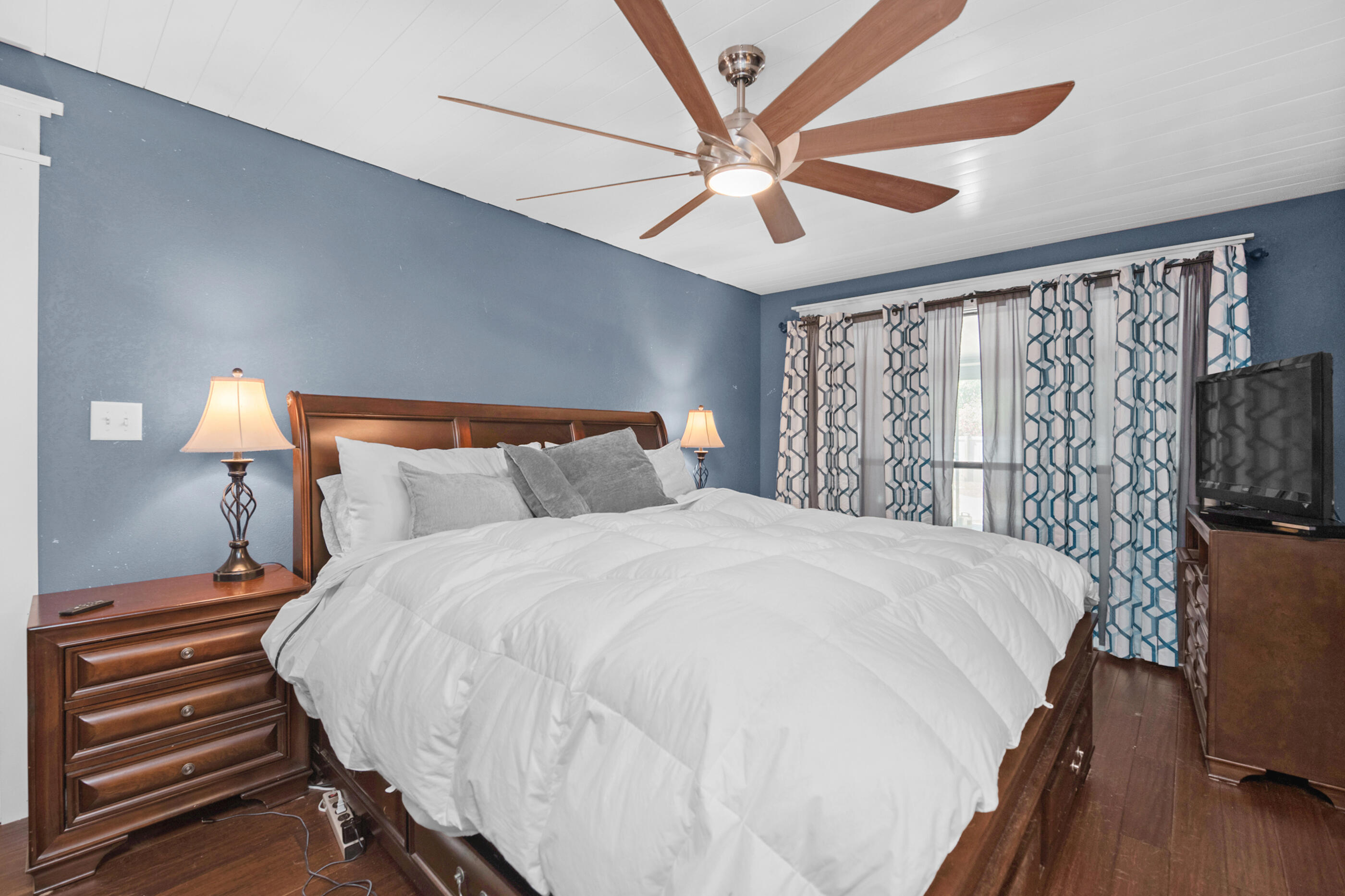 6539 Robar Tesora Street Navarre, FL 32566 - Photo 20 of 48 a bedroom with a bed and a chandelier