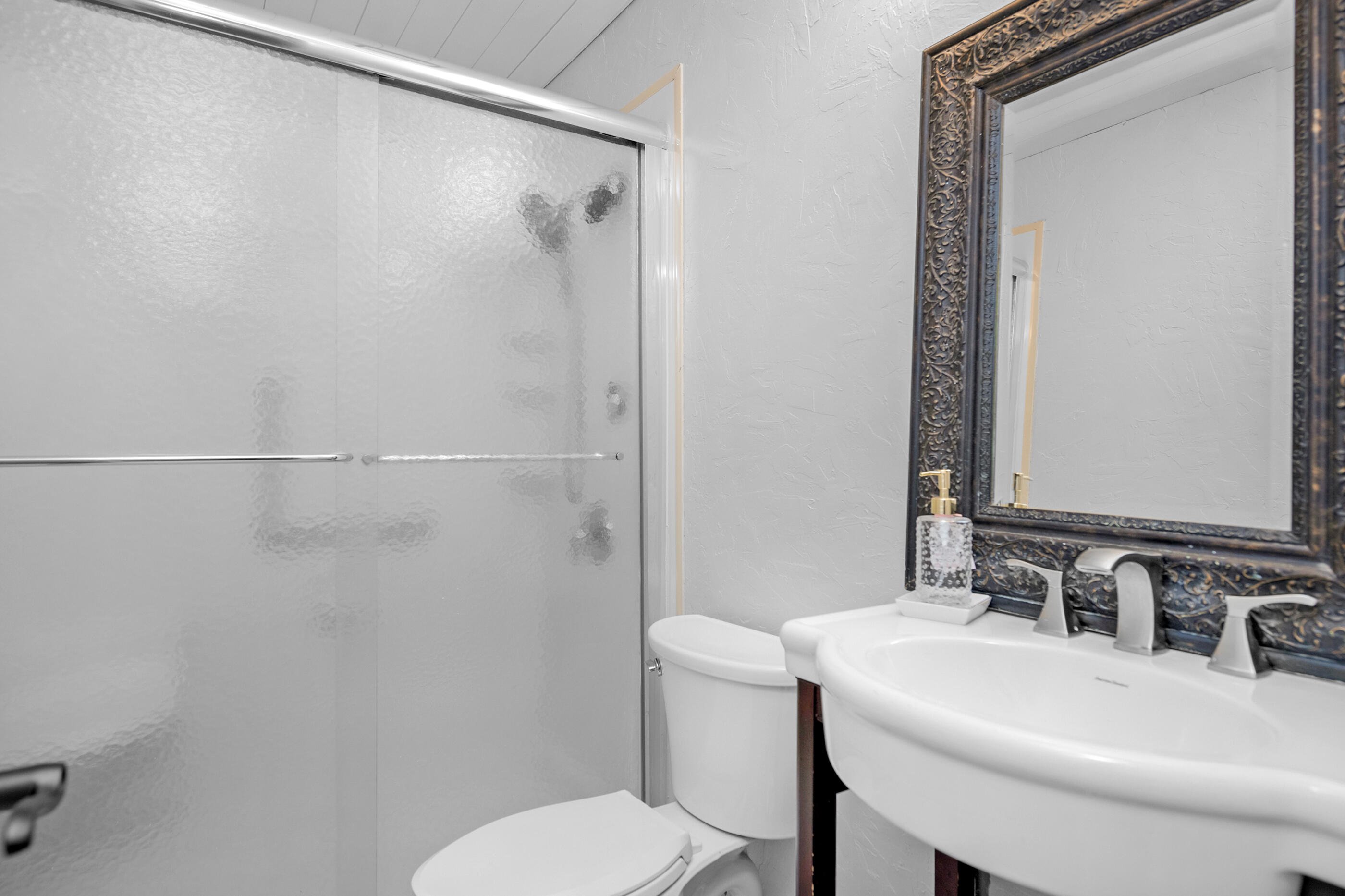 6539 Robar Tesora Street Navarre, FL 32566 - Photo 23 of 48 a bathroom with a sink toilet and a mirror