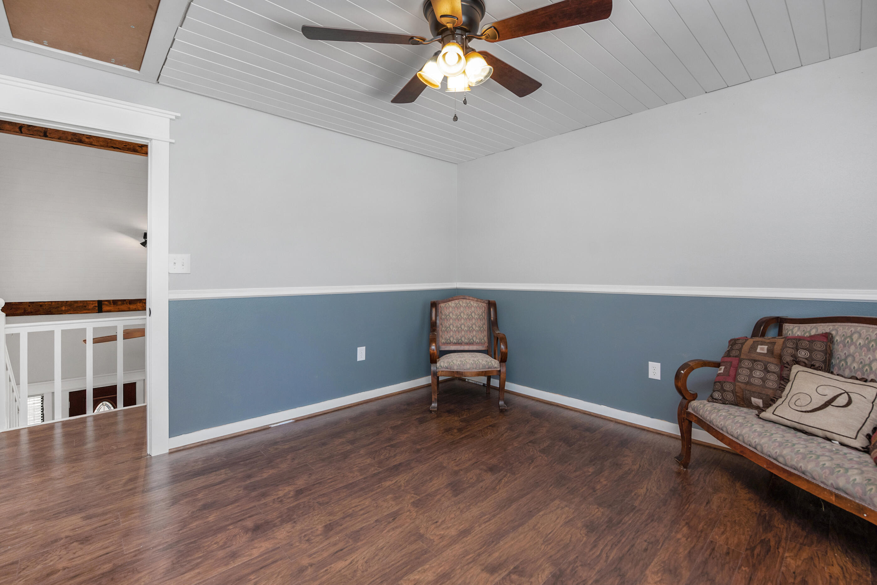 6539 Robar Tesora Street Navarre, FL 32566 - Photo 27 of 48 a living room with furniture and a wooden floor