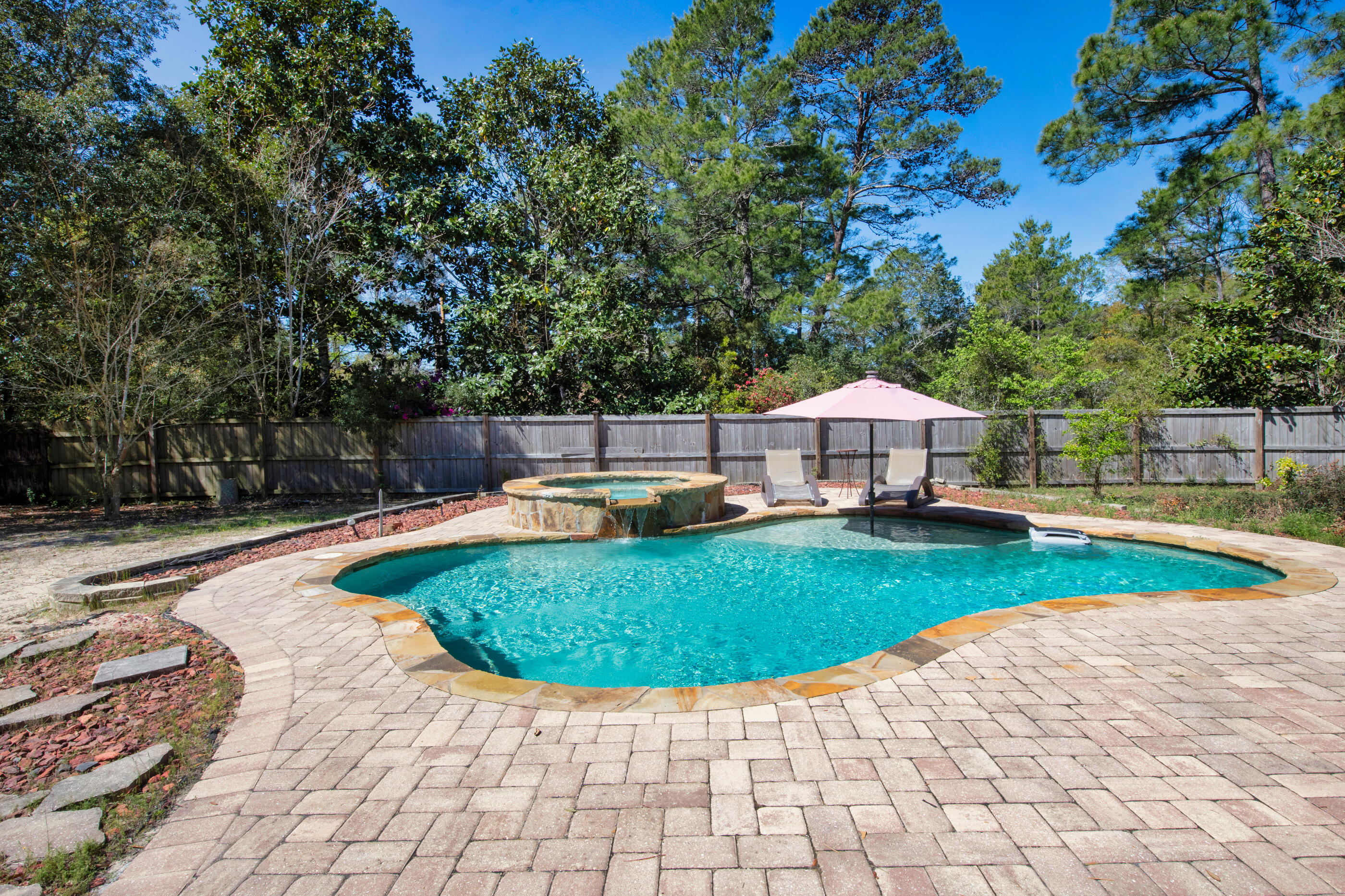 6539 Robar Tesora Street Navarre, FL 32566 - Photo 31 of 48 a view of a swimming pool with a patio and a yard