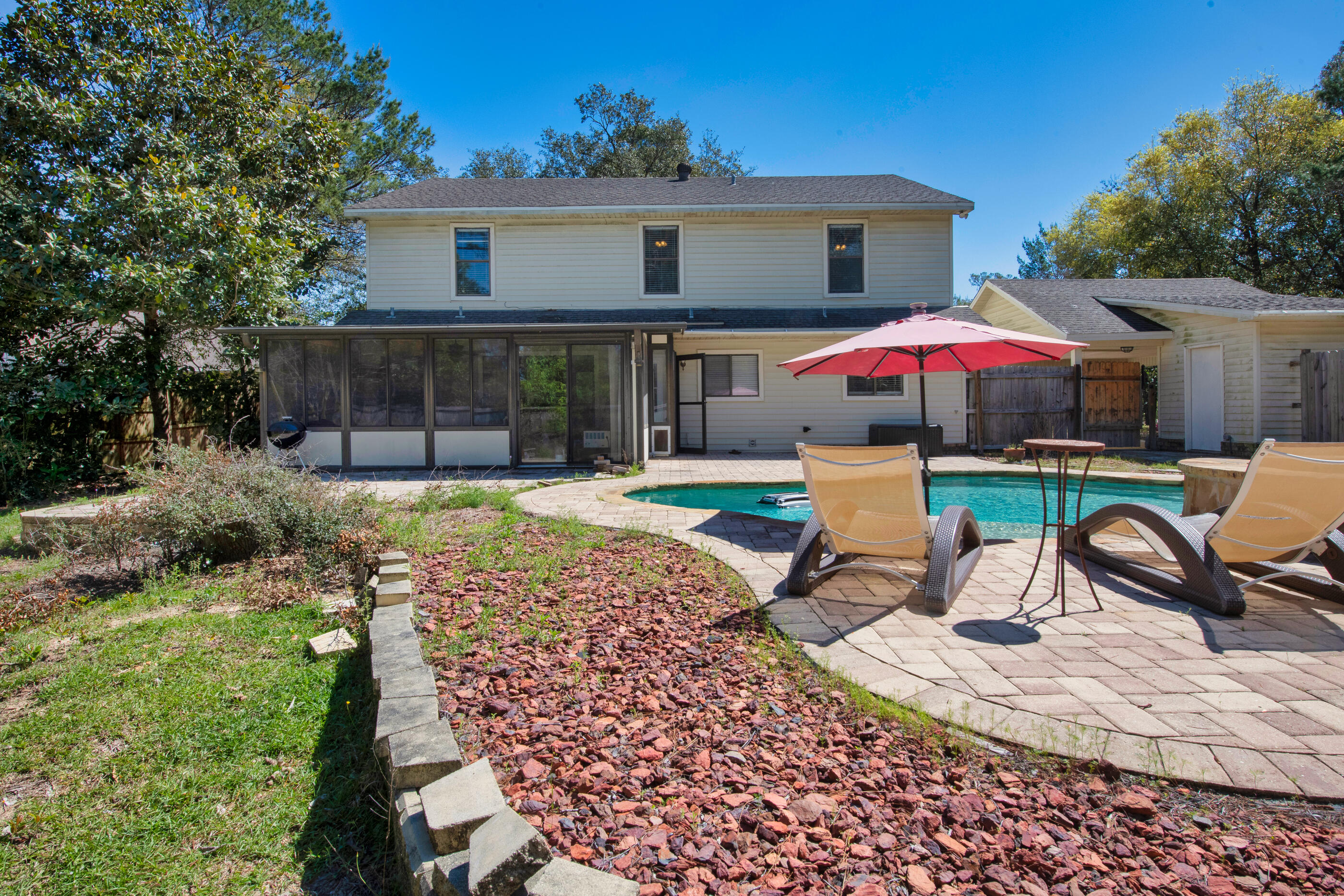 6539 Robar Tesora Street Navarre, FL 32566 - Photo 34 of 48 a view of a house with backyard and sitting area