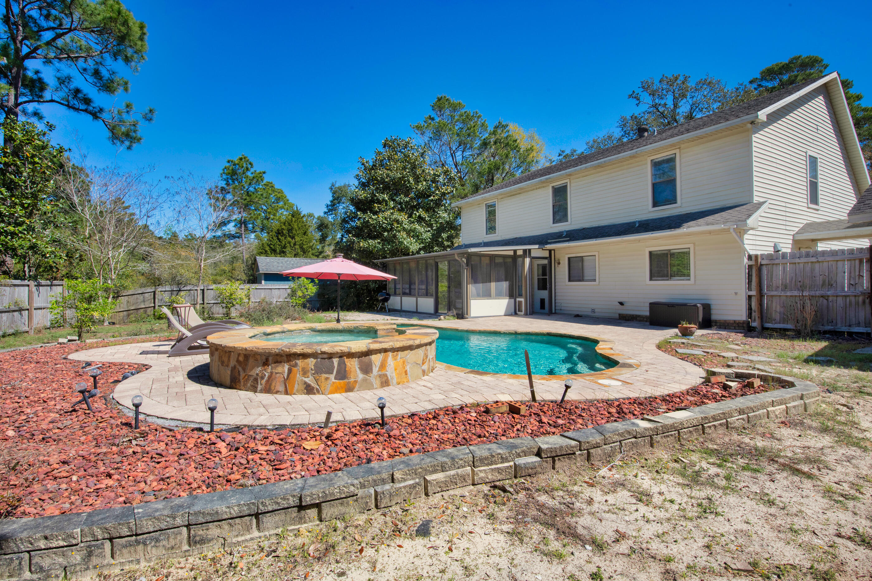 6539 Robar Tesora Street Navarre, FL 32566 - Photo 35 of 48 a swimming pool with outdoor seating