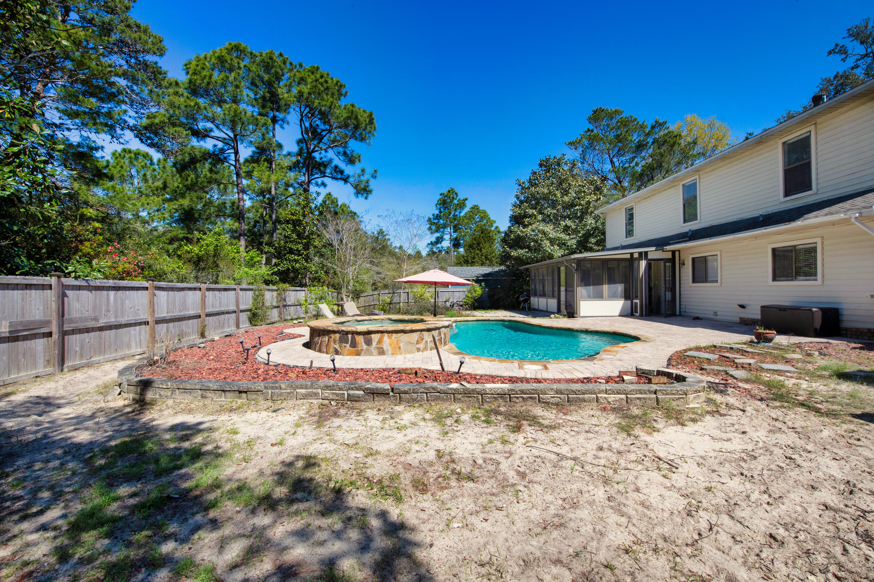 6539 Robar Tesora Street Navarre, FL 32566 - Photo 36 of 48 a view of a backyard with a bench and plants