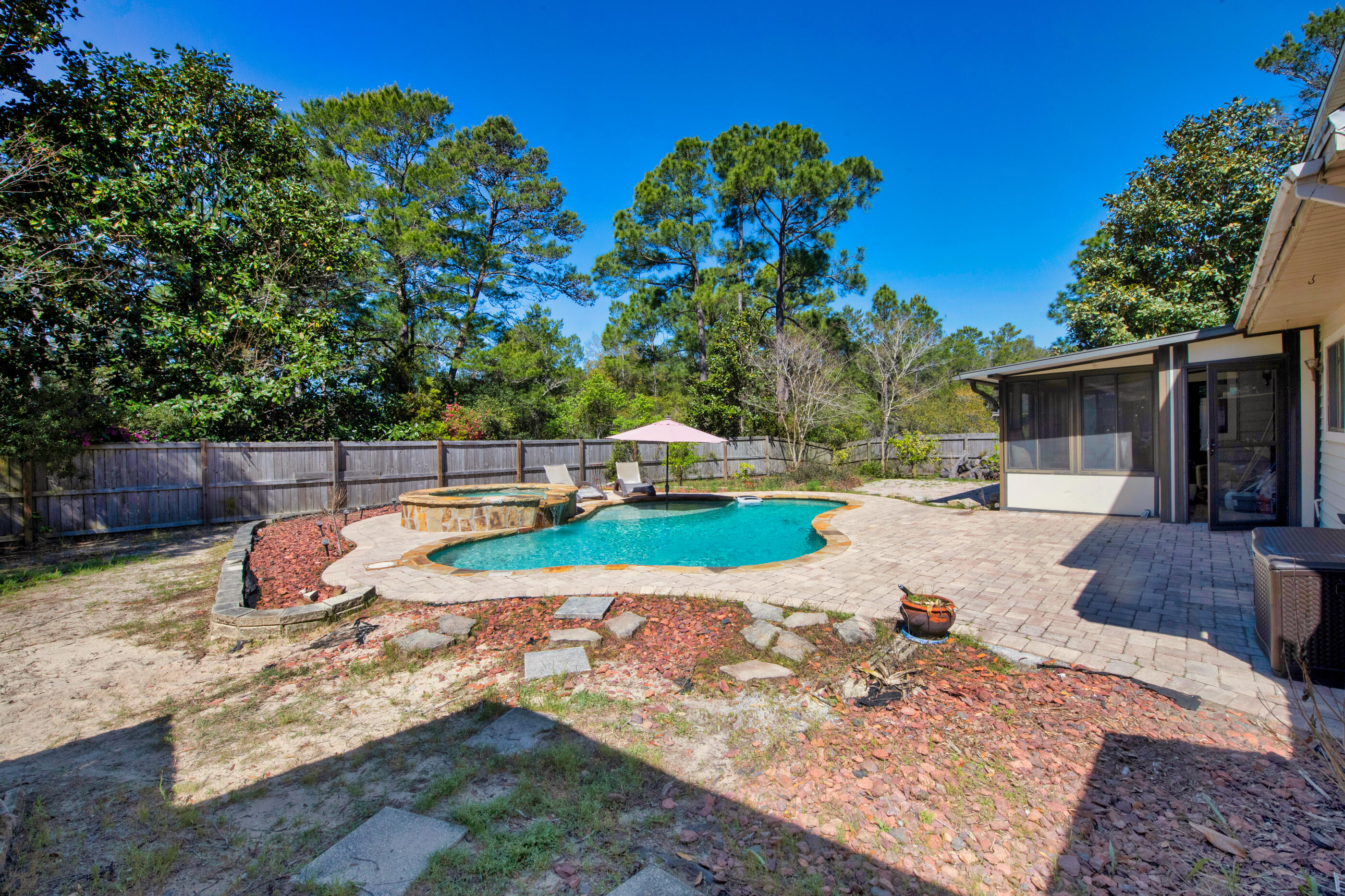 6539 Robar Tesora Street Navarre, FL 32566 - Photo 37 of 48 a view of a backyard with plants and patio