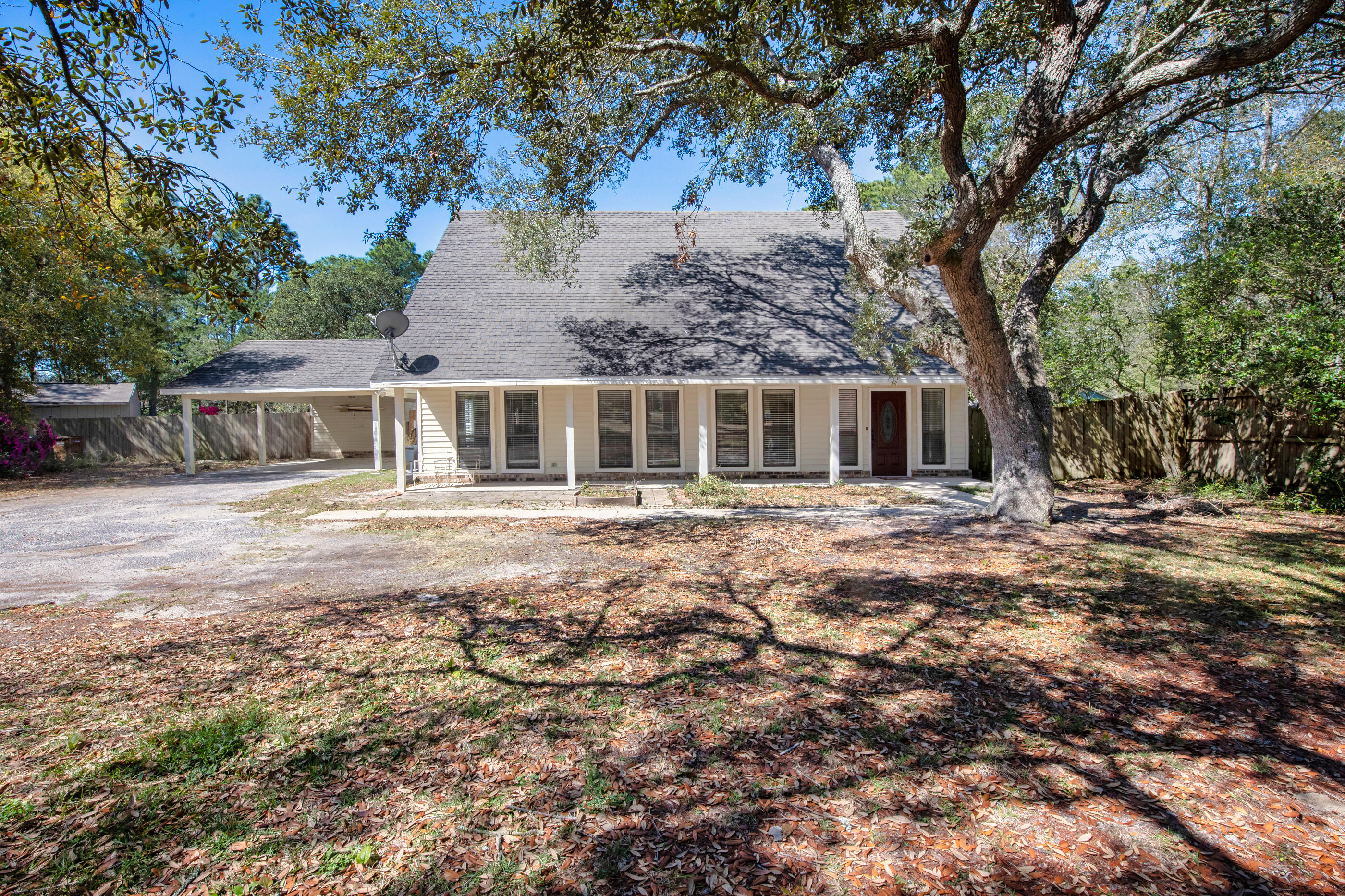 6539 Robar Tesora Street Navarre, FL 32566 - Photo 5 of 48 a front view of a house with a yard