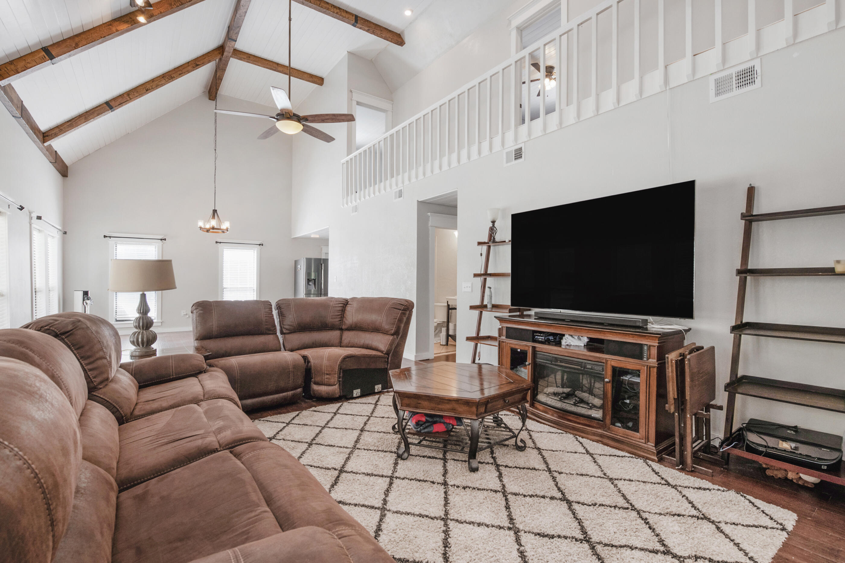 6539 Robar Tesora Street Navarre, FL 32566 - Photo 7 of 48 a living room with furniture and a flat screen tv
