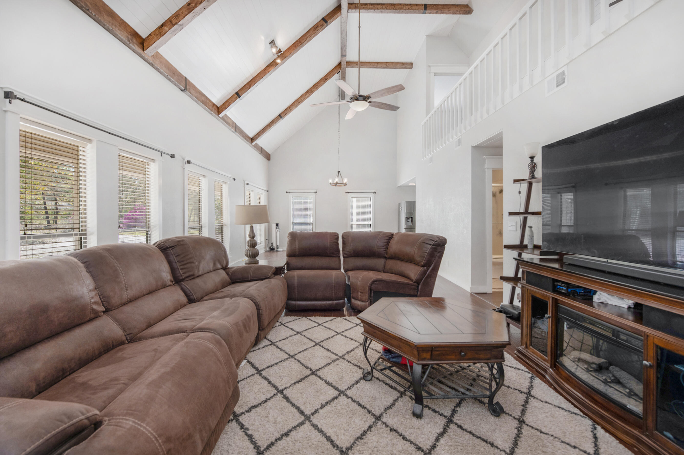6539 Robar Tesora Street Navarre, FL 32566 - Photo 9 of 48 a living room with furniture a flat screen tv and a window