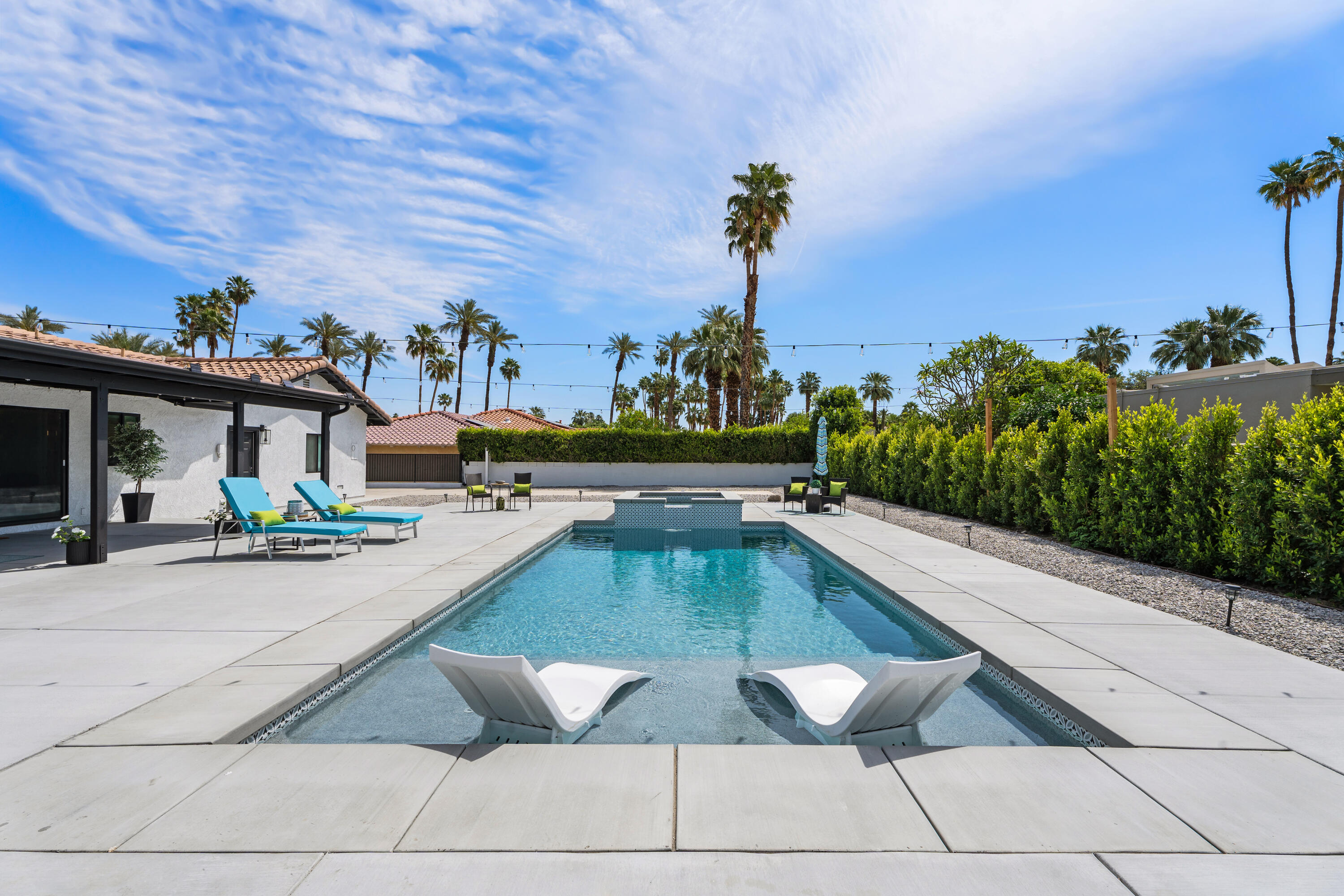 70443 Chappel Road Rancho Mirage, CA 92270 - Photo 2 of 36 a view of a patio with swimming pool table and chairs