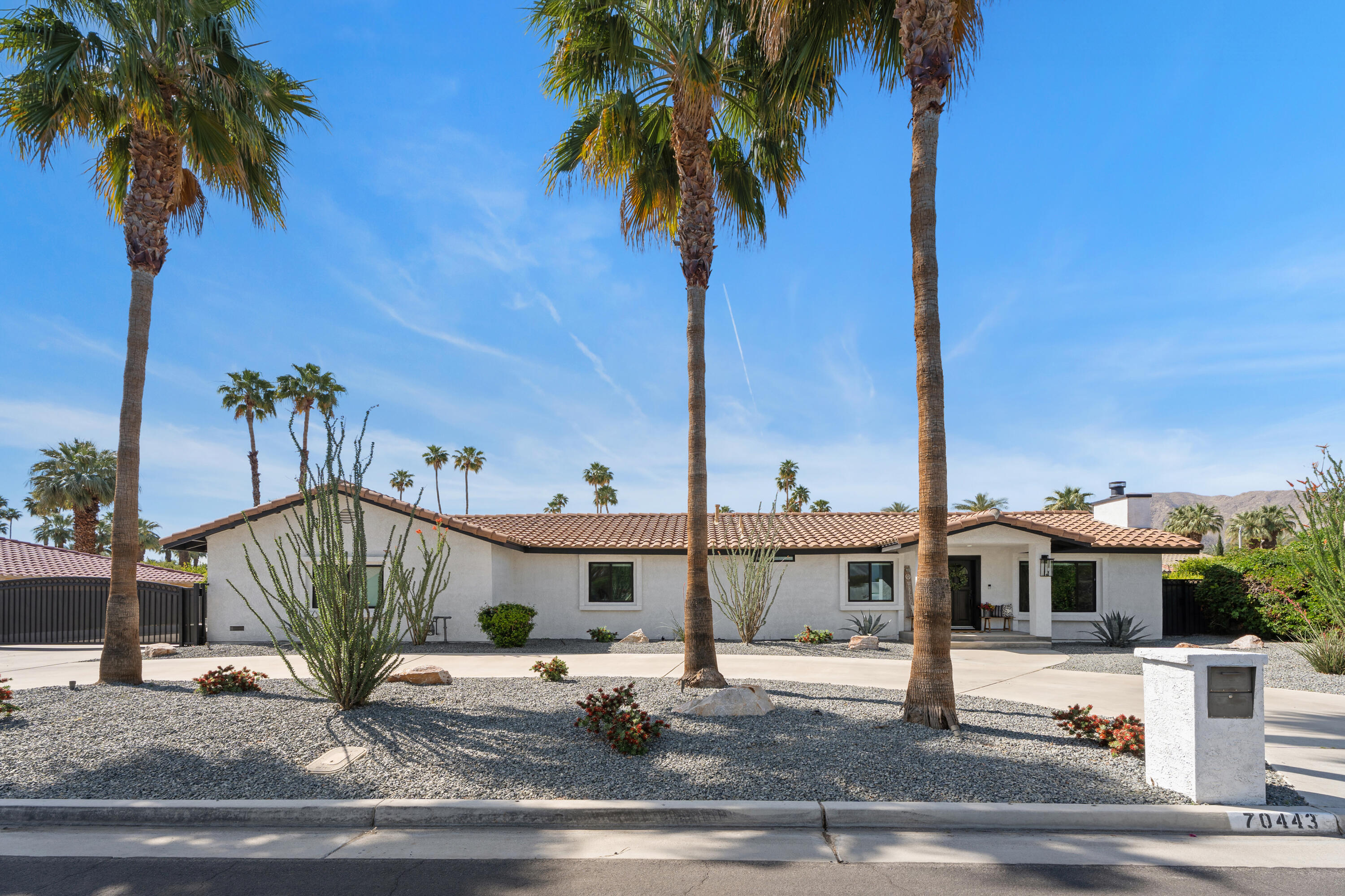 70443 Chappel Road Rancho Mirage, CA 92270 - Photo 32 of 36 a palm tree sitting in front of a house with a fountain