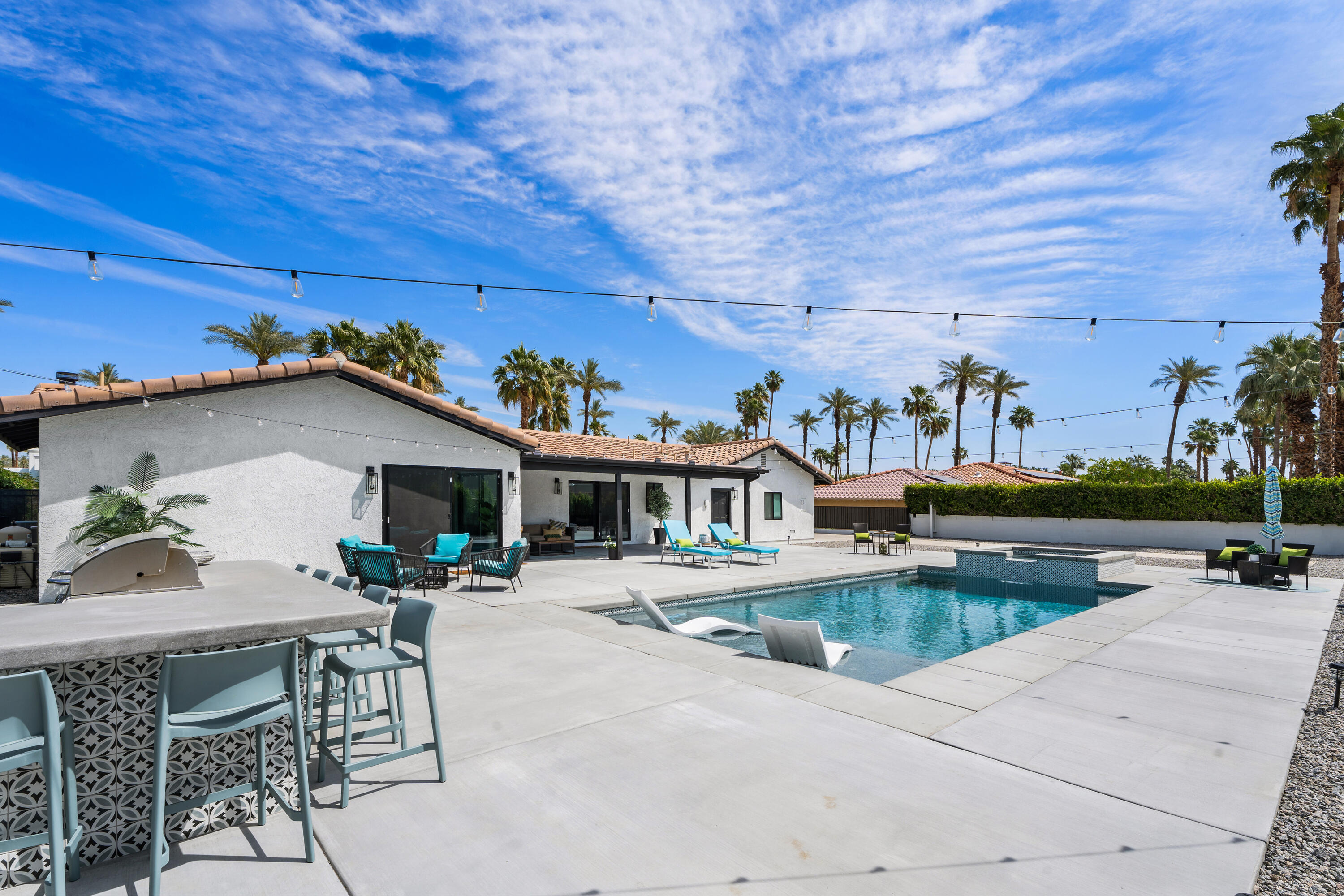 70443 Chappel Road Rancho Mirage, CA 92270 - Photo 4 of 36 a view of a patio with dining table and chairs with plants and wooden fence