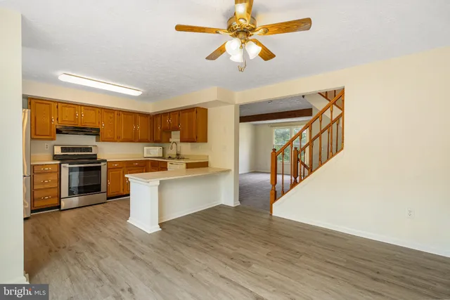 a kitchen with a stove a sink and a microwave
