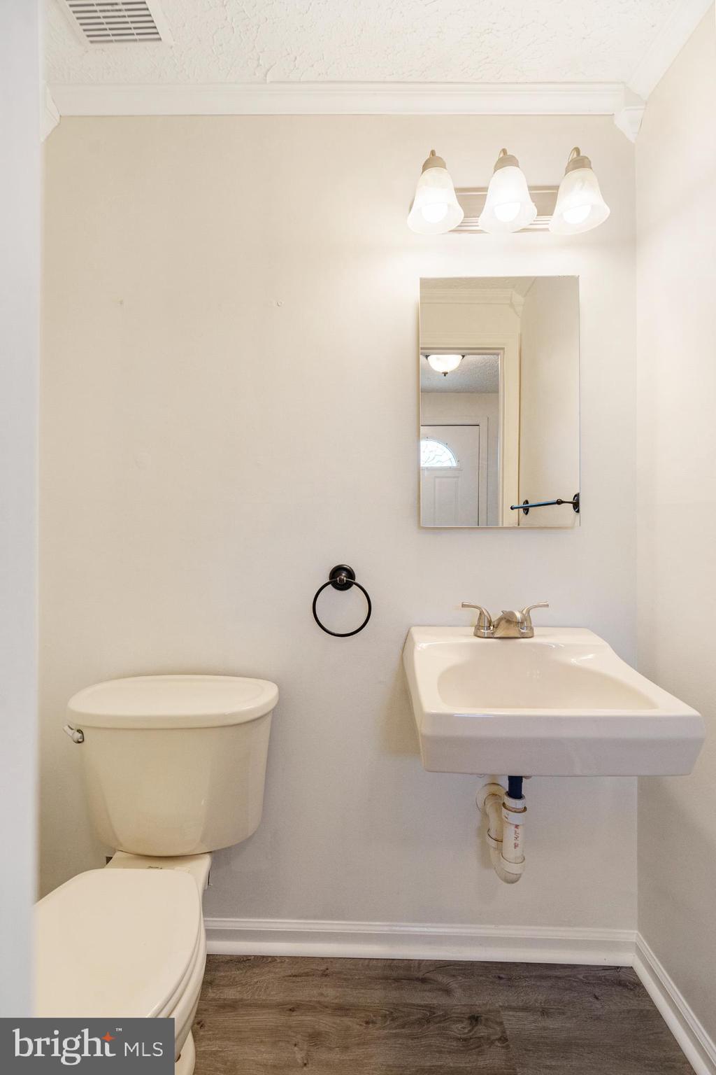 3322 Raccoon Court Abingdon, MD 21009 - Photo 19 of 44 a bathroom with a toilet sink and mirror