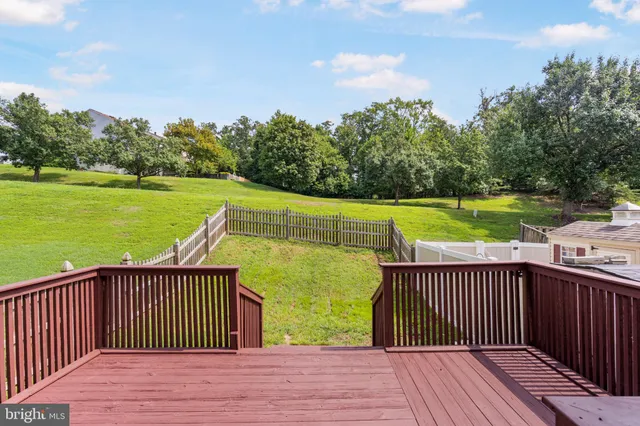 a view of a house with a wooden deck