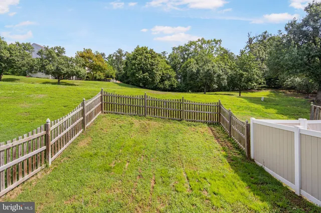 a view of a house with a wooden deck and furniture