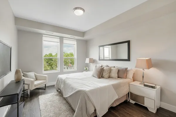 a bedroom with bed and a window