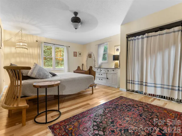 a living room with furniture a rug and a window