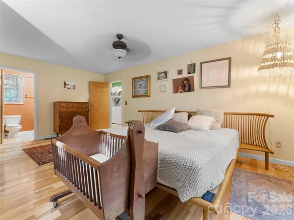 a bedroom with furniture and wooden floor