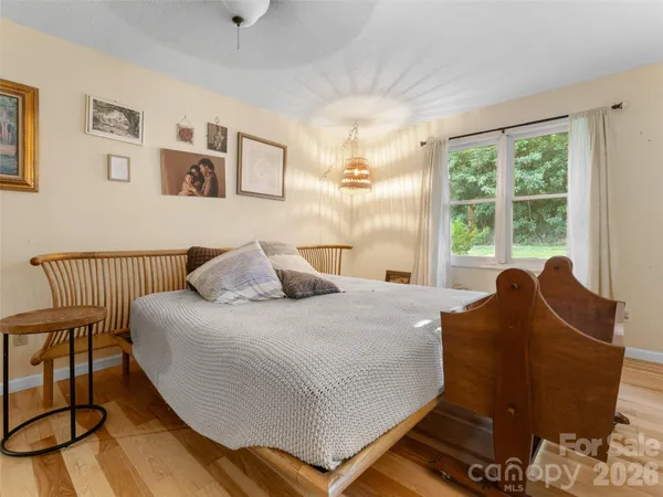 a bed sitting in a bedroom next to a window