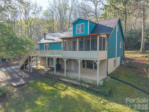 a view of a house with yard and sitting area