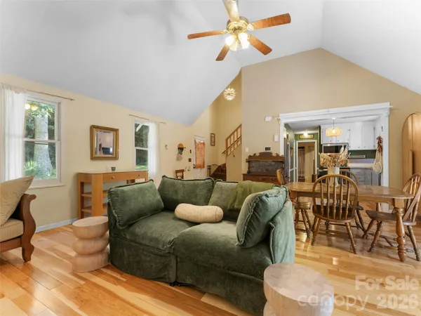 a living room with furniture a ceiling fan and a rug