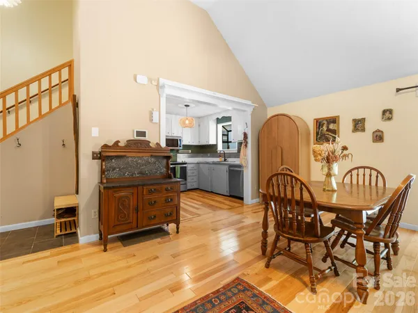 a dining room with furniture and wooden floor