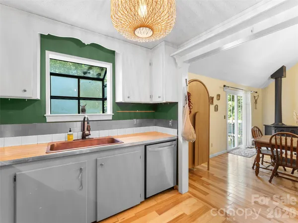 a kitchen with a sink cabinets and window