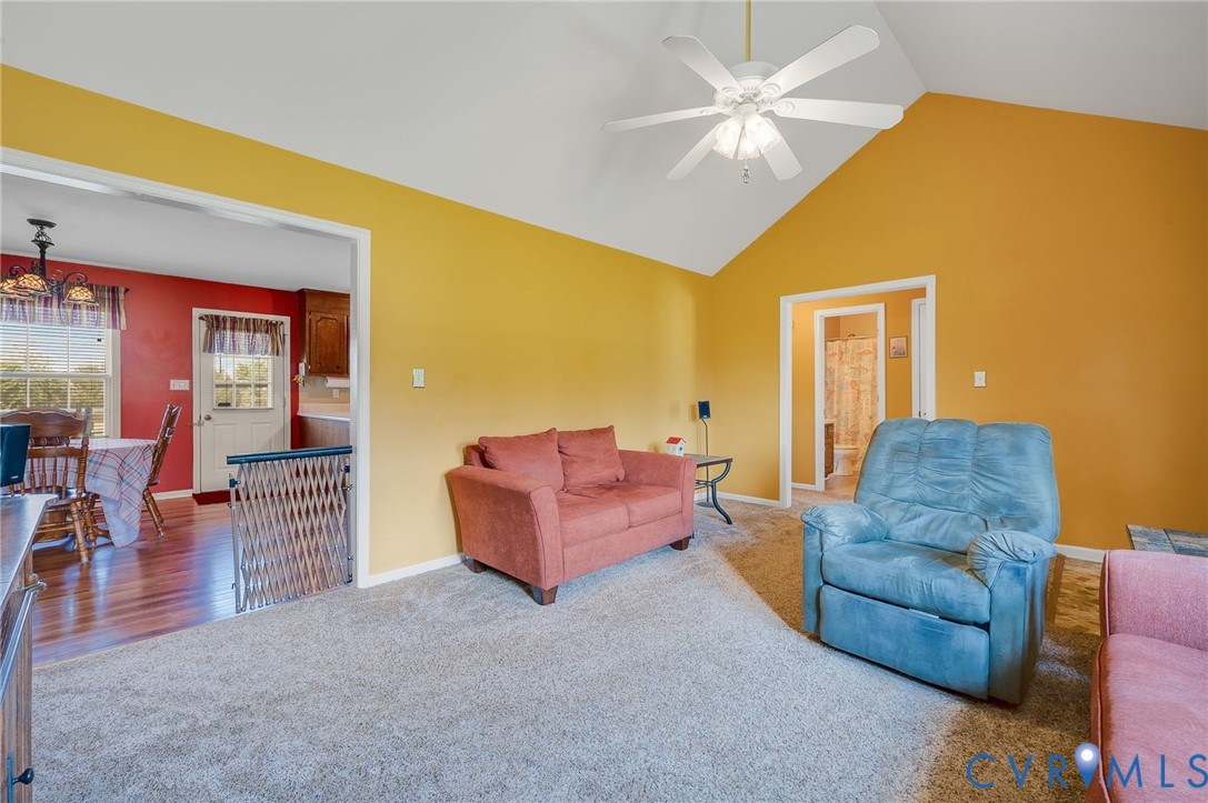 5280 West Quaker Road Disputanta, VA 23875 - Photo 21 of 33 a living room with furniture and a dining table