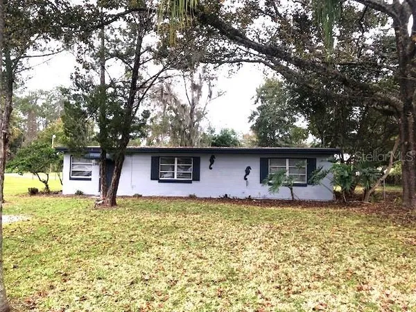 a house that has a tree in front of it