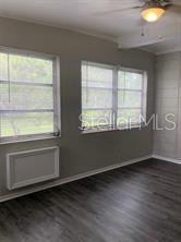 298 South 3rd Street Lake Mary, FL 32746 - Photo 6 of 12 an empty room with wooden floor and windows