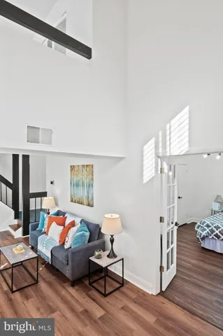 a bedroom with furniture and wooden floor