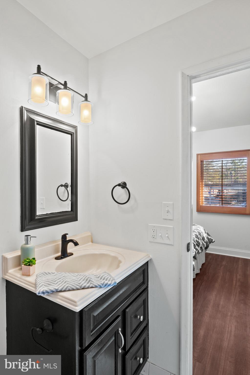 11246 Snowflake Court, Unit A121 Columbia, MD 21044 - Photo 18 of 36 a bathroom with a granite countertop sink and a mirror