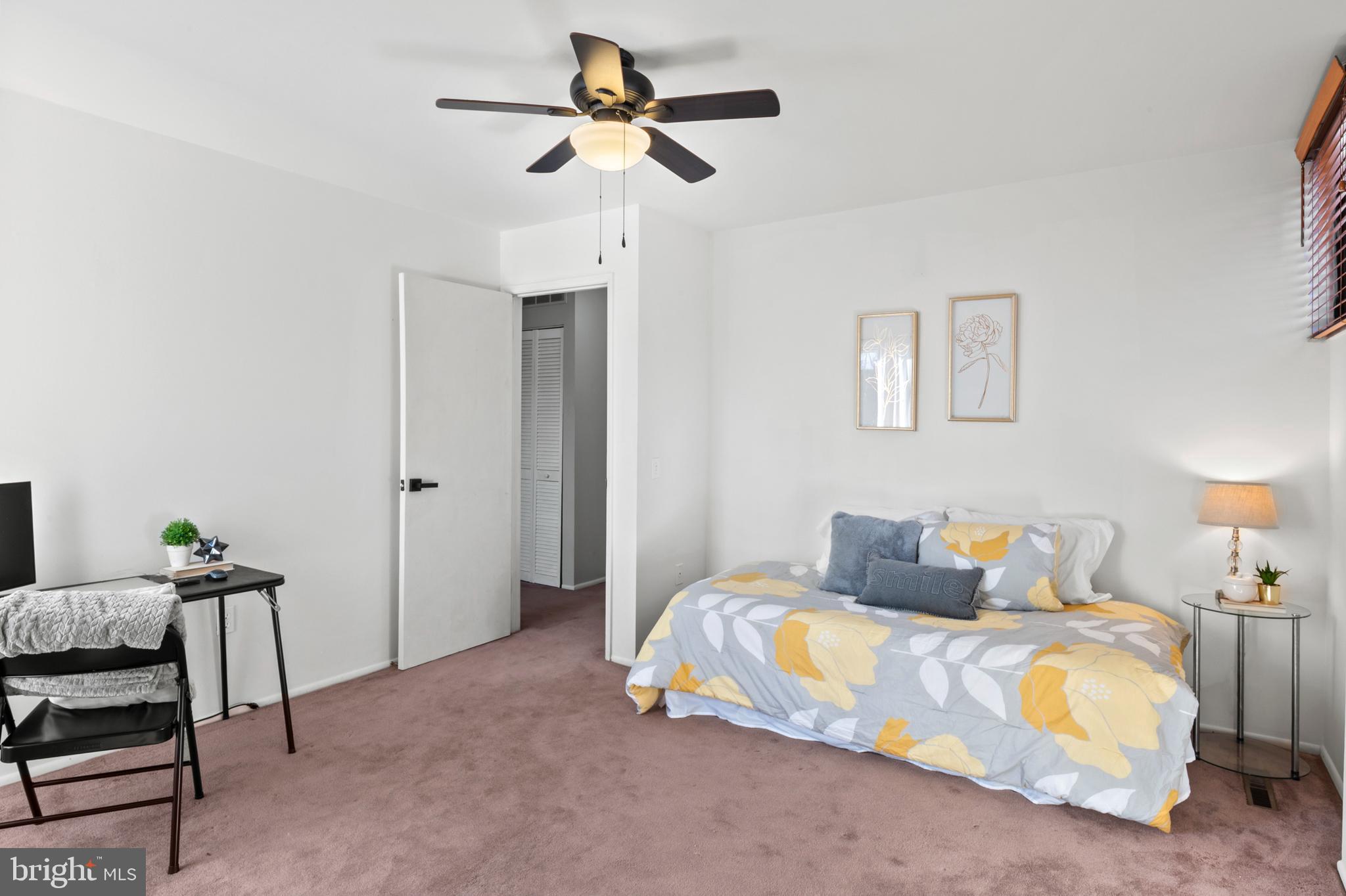 11246 Snowflake Court, Unit A121 Columbia, MD 21044 - Photo 26 of 36 a bedroom with a bed and a chair