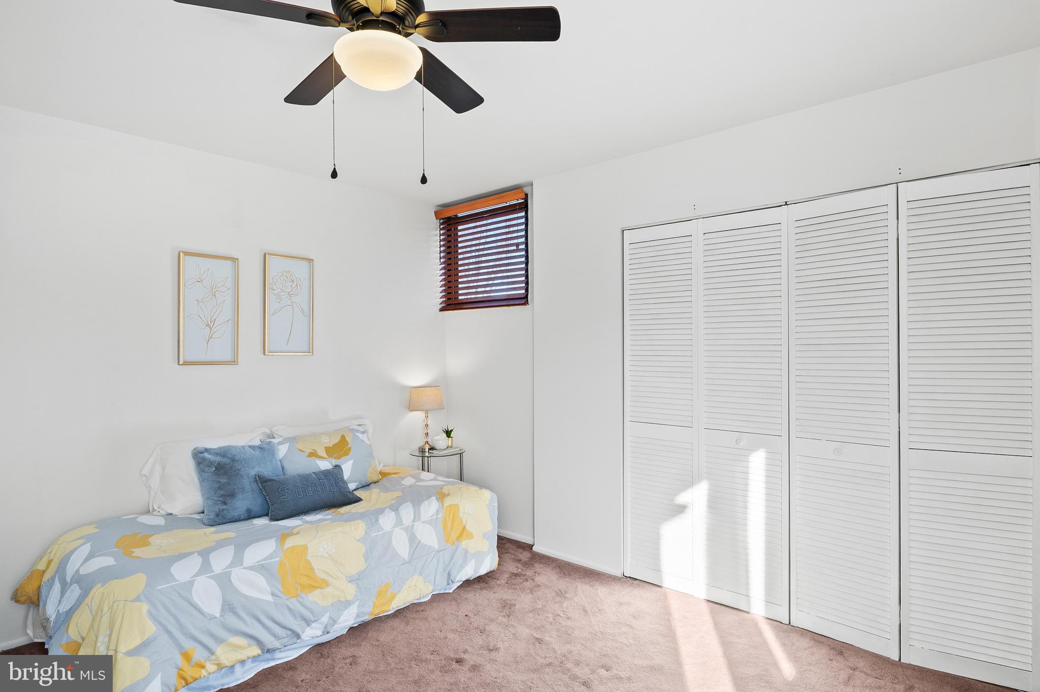 11246 Snowflake Court, Unit A121 Columbia, MD 21044 - Photo 27 of 36 a bedroom with a bed and a chandelier