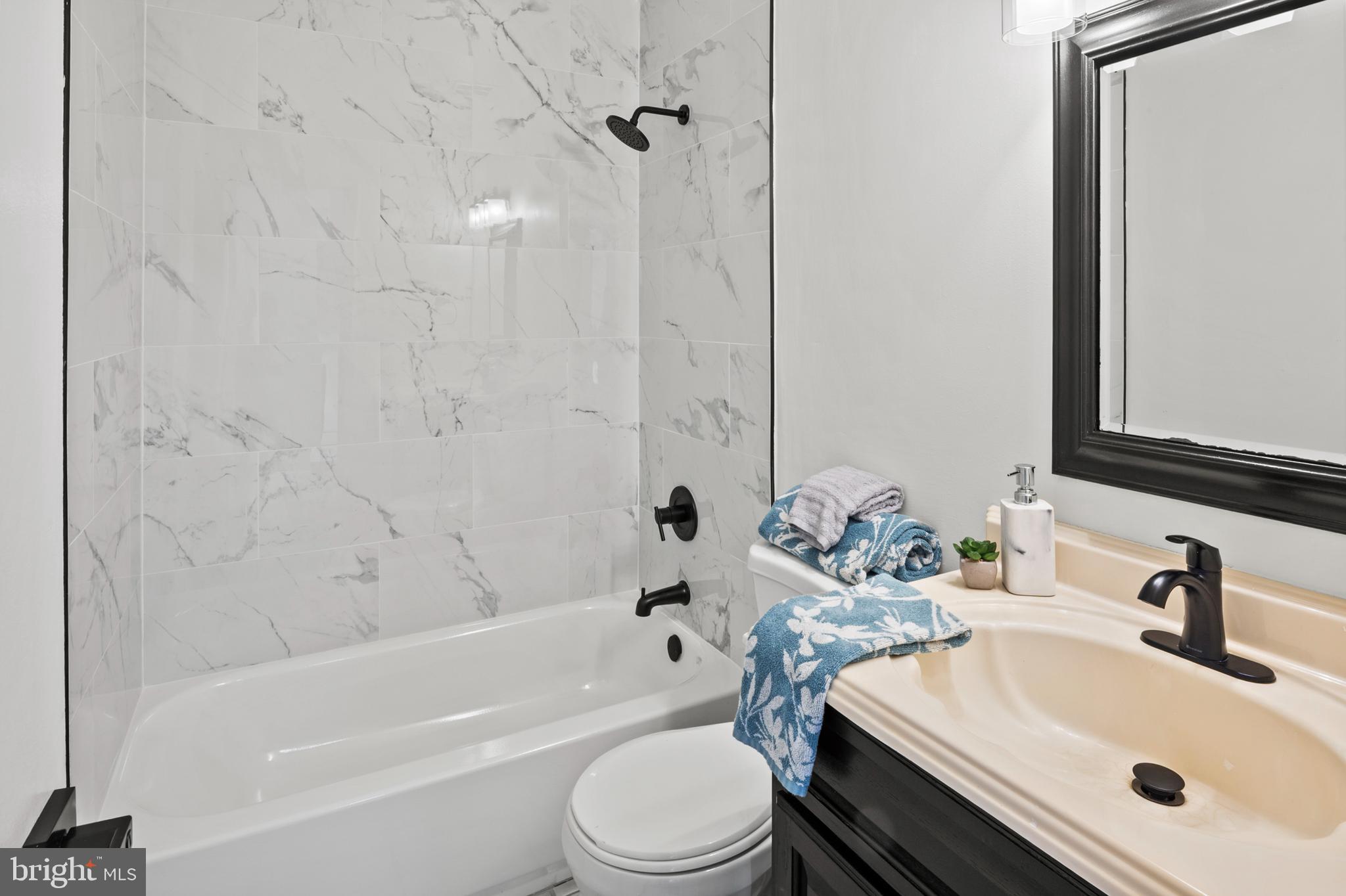 11246 Snowflake Court, Unit A121 Columbia, MD 21044 - Photo 29 of 36 a bathroom with a sink a toilet and a bathtub