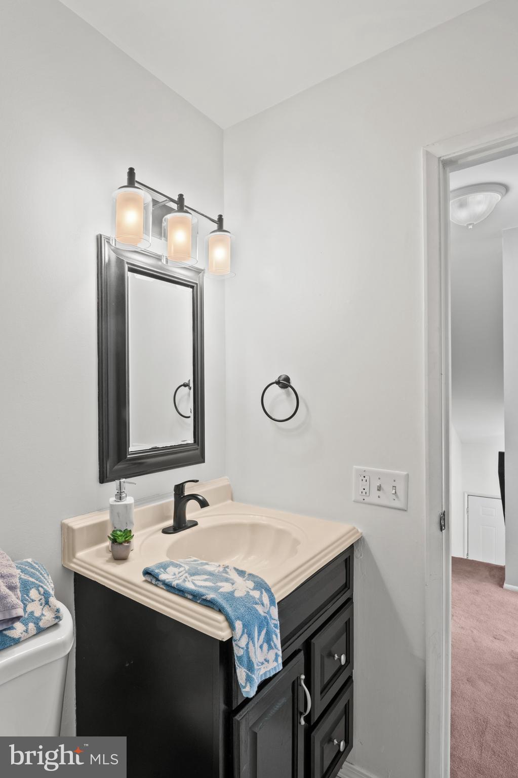 11246 Snowflake Court, Unit A121 Columbia, MD 21044 - Photo 30 of 36 a bathroom with a granite countertop sink and a mirror