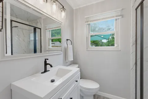 a bathroom with a sink toilet and shower