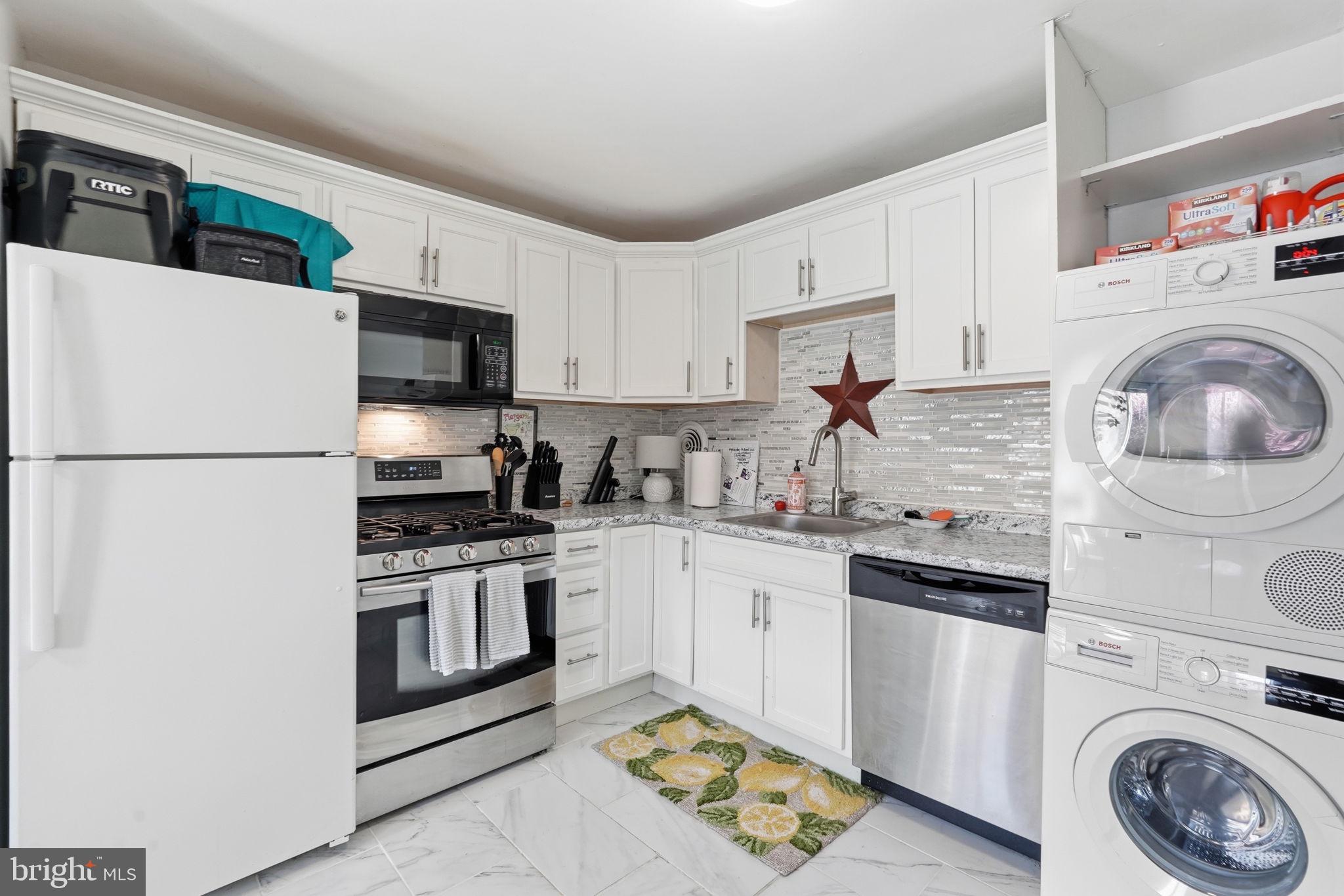 5017 7th Road South, Unit 102 Arlington, VA 22204 - Photo 11 of 40 a kitchen with stainless steel appliances granite countertop a sink a stove a refrigerator and cabinets