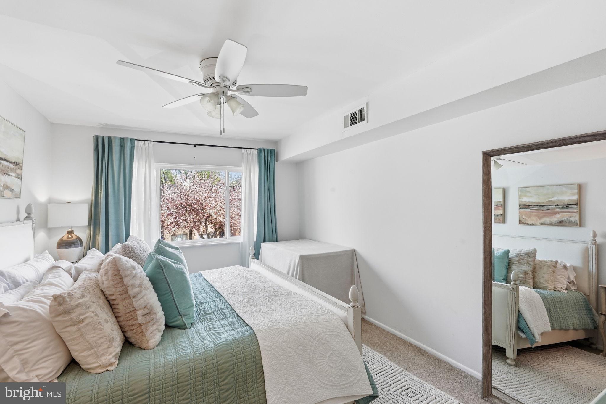 5017 7th Road South, Unit 102 Arlington, VA 22204 - Photo 17 of 40 a bedroom with a bed and a chandelier