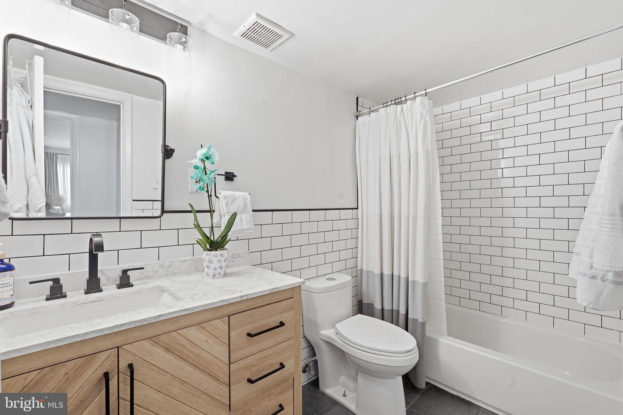 5017 7th Road South, Unit 102 Arlington, VA 22204 - Photo 19 of 40 a bathroom with a sink toilet and shower