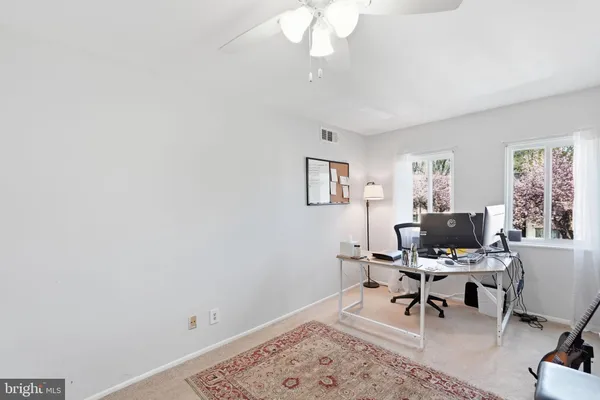 a workspace with wooden floor and a window