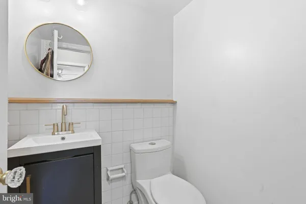 a bathroom with a toilet a sink and a mirror